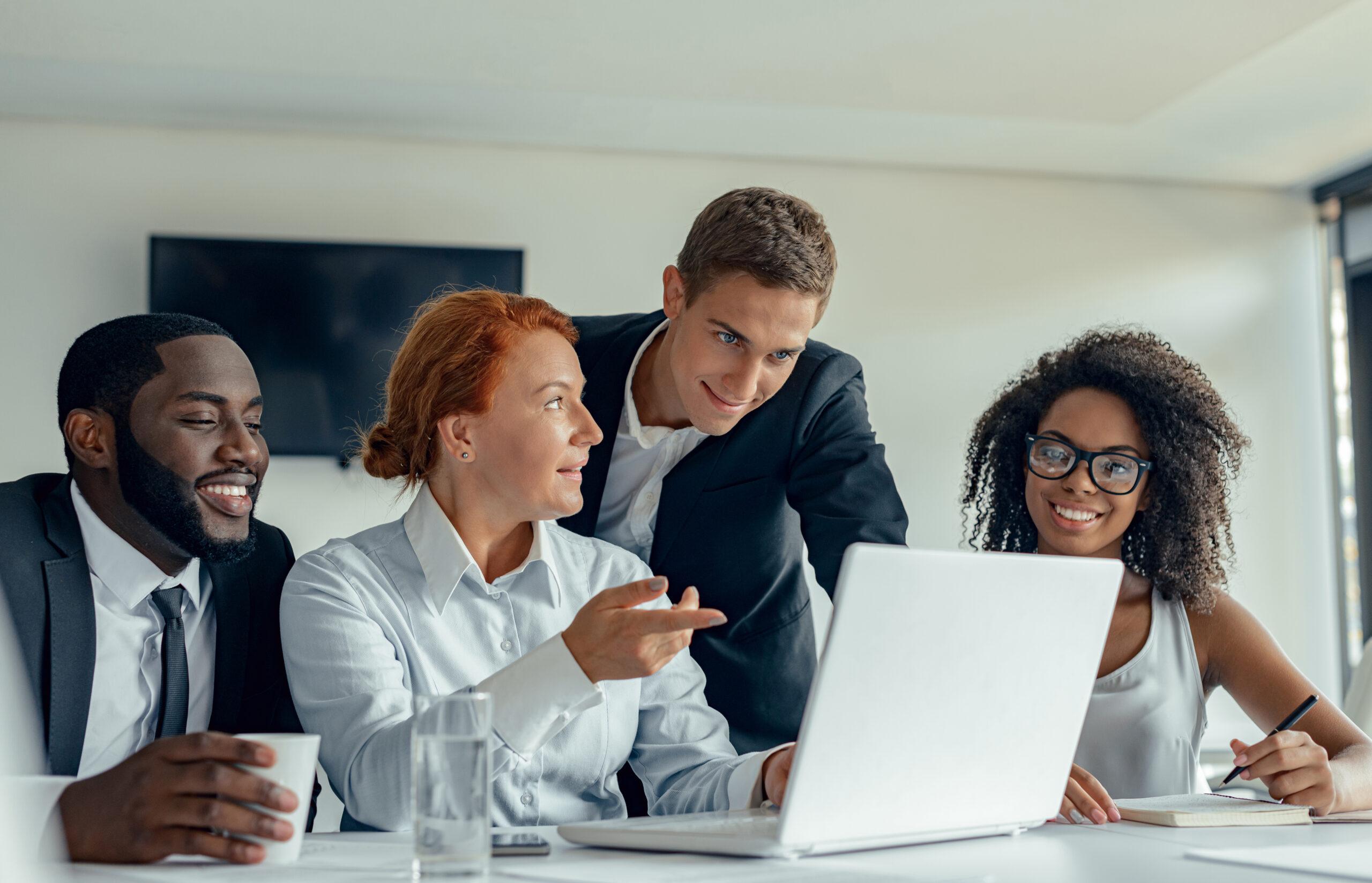 people business suits working brainstorming together while sitting desk with laptop white modern office scaled